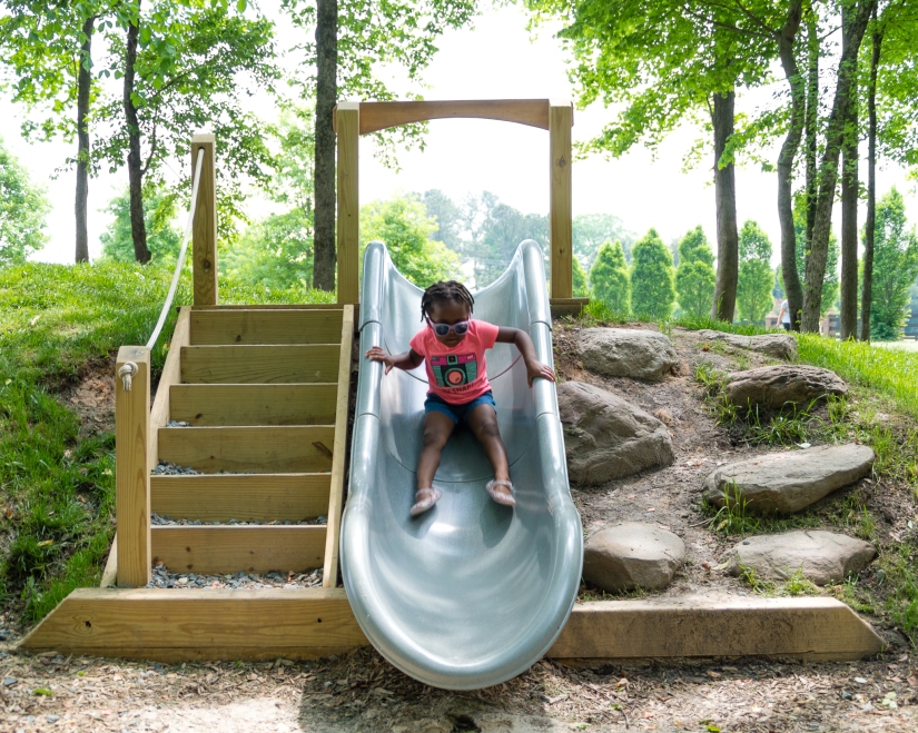 Maxine is flying down the slide.